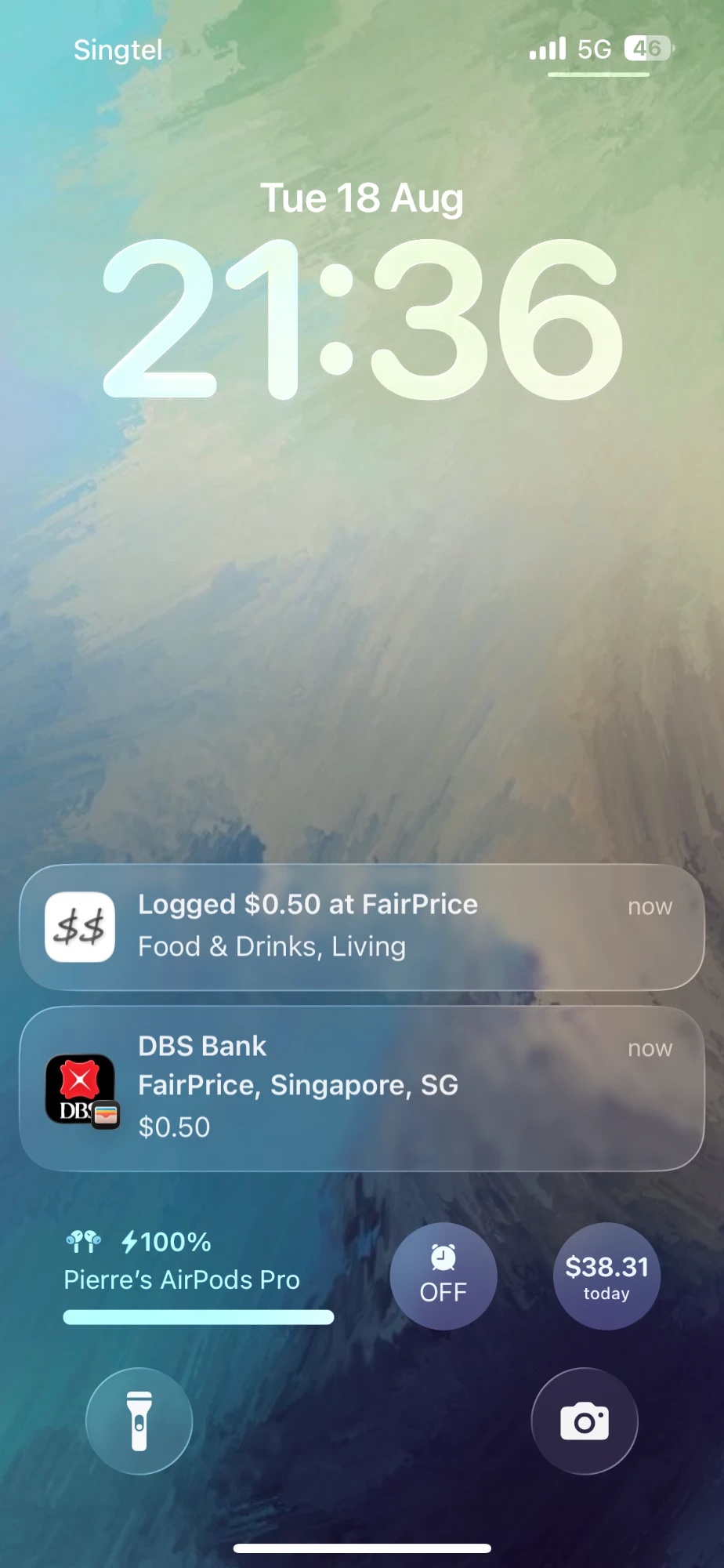 iPhone lock screen with a CashJot notification reading Logged $0.50 at FairPrice, directly above the bank's own payment notification for the same tap